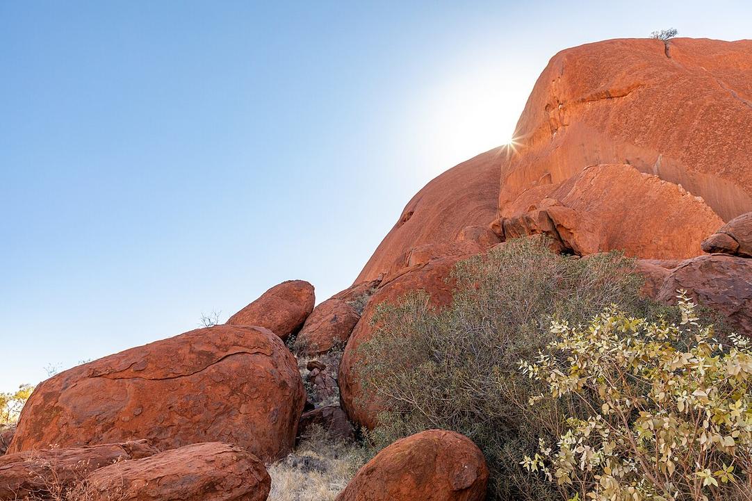 The dry rustle of spinifex grass blends with the warm desert air at the Mutitjulu Waterhole trailhead.