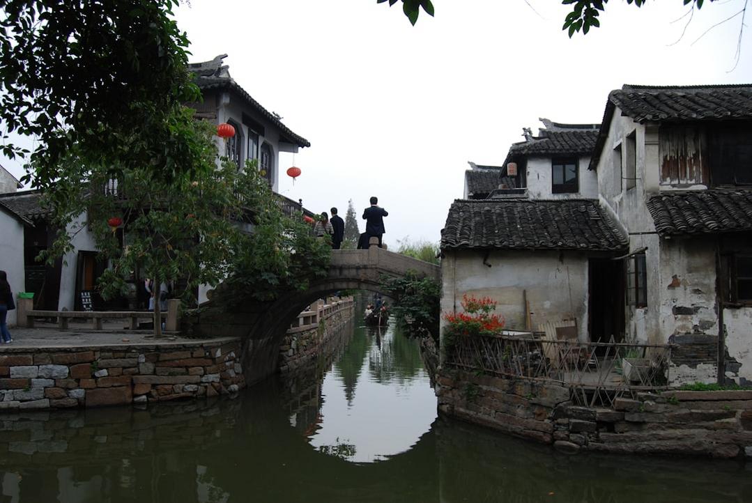 Stroll along the ancient stone bridge at sunset, watching the reflections dance on the water.